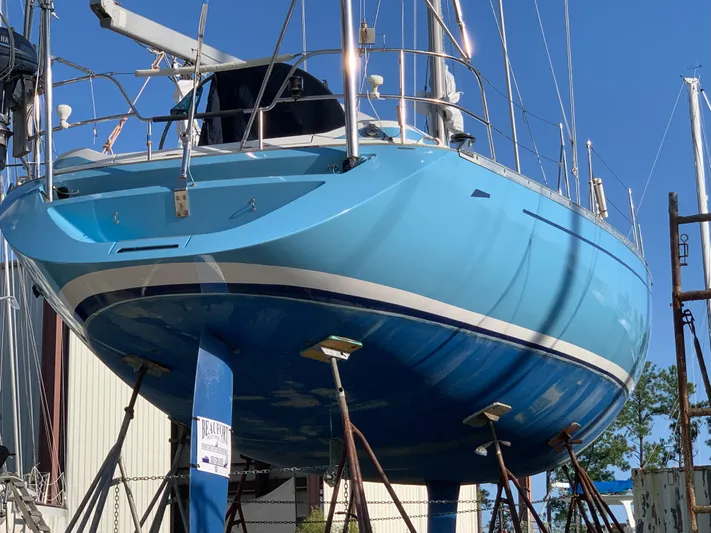 Cavallino Yacht Photos Pics Grand Soleil 46.3 sailboat from 2000, vibrant blue hull, docked for maintenance.