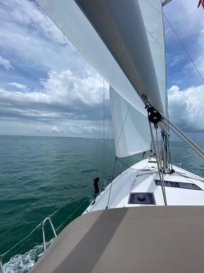  Yacht Photos Pics Sailing Jeanneau Sun Odyssey 51, 2017 model, on open sea under cloudy skies.
