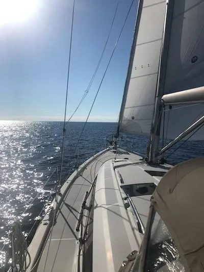  Yacht Photos Pics 2017 Jeanneau Sun Odyssey 51 sailing on open sea under clear blue sky.