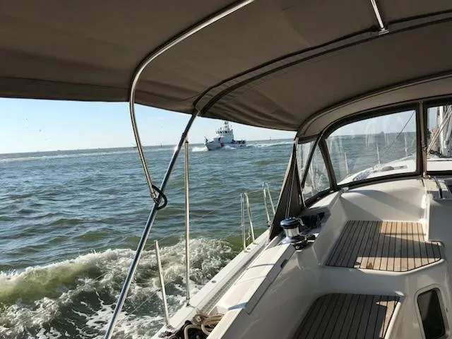  Yacht Photos Pics Jeanneau Sun Odyssey 51 sailing on open water, view from cockpit, 2017 model.