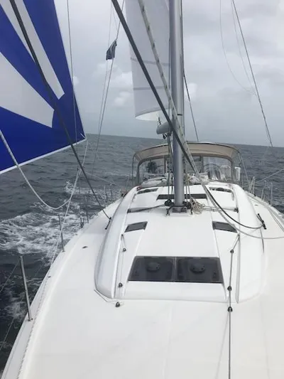  Yacht Photos Pics Jeanneau Sun Odyssey 51 sailing on open sea, 2017 model, with sails unfurled.