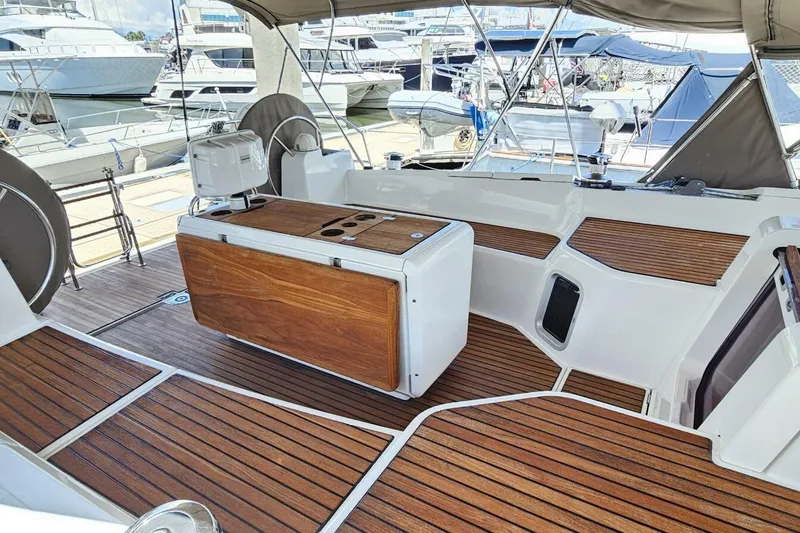  Yacht Photos Pics 2017 Jeanneau Sun Odyssey 51 yacht cockpit with wooden flooring and seating at marina.