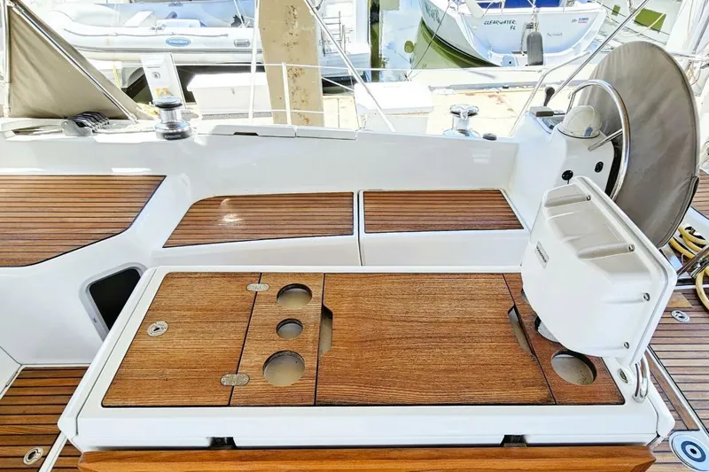  Yacht Photos Pics Cockpit of 2017 Jeanneau Sun Odyssey 51 with wooden deck and steering wheel.