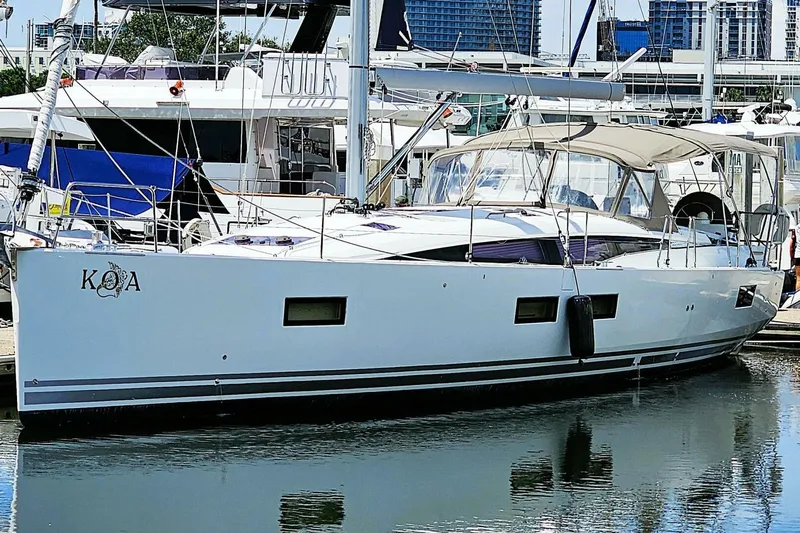  Yacht Photos Pics 2017 Jeanneau Sun Odyssey 51 yacht docked at marina, sleek design, white hull.