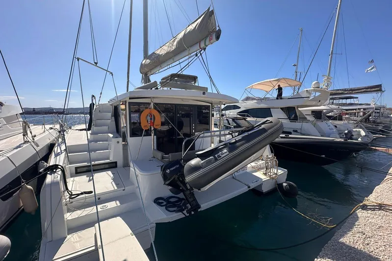 Yulia Yacht Photos Pics 2023 Bali 4.2 catamaran docked at marina, sunny day, clear blue sky.
