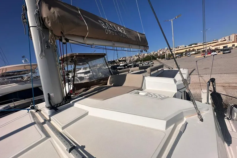 Yulia Yacht Photos Pics 2023 Bali 4.2 catamaran docked at marina under clear blue sky.