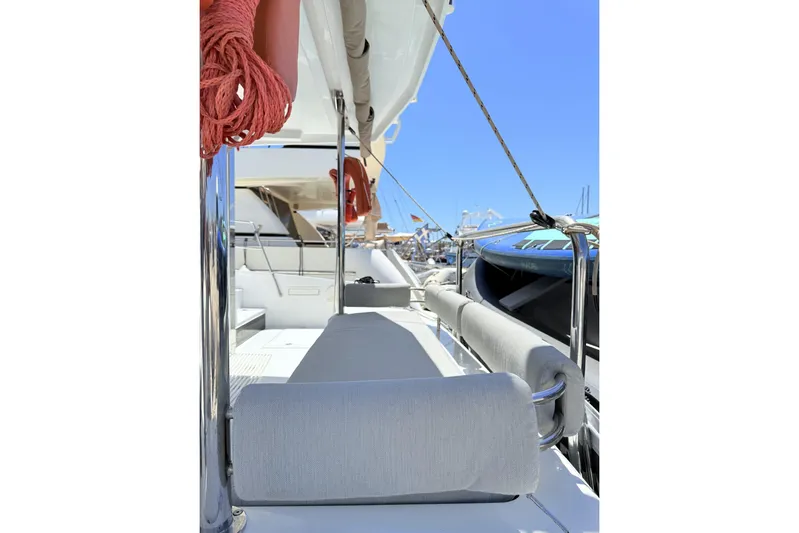 Yulia Yacht Photos Pics 2023 Bali 4.2 yacht deck with seating, ropes, and clear blue sky.