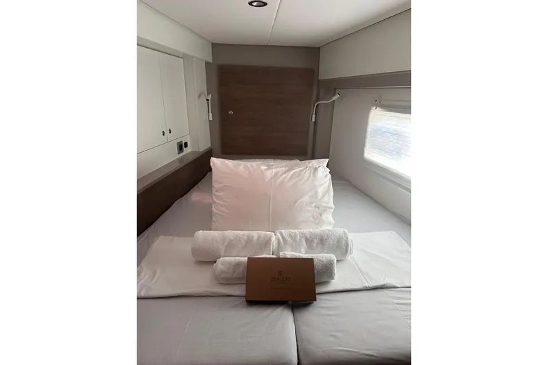 Yulia Yacht Photos Pics Luxurious cabin interior of 2023 Bali 4.2 yacht with neatly arranged bedding.