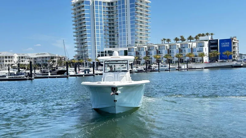 The Reel Commander Yacht Photos Pics 2026 Sea Fox 368 Commander boat cruising near modern waterfront buildings.