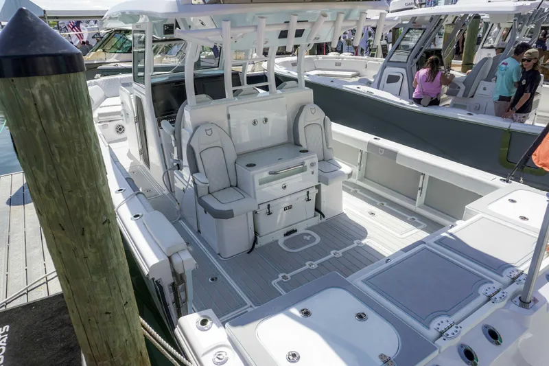 The Reel Commander Yacht Photos Pics 2026 Sea Fox 368 Commander boat interior with seating and storage, docked at a marina.
