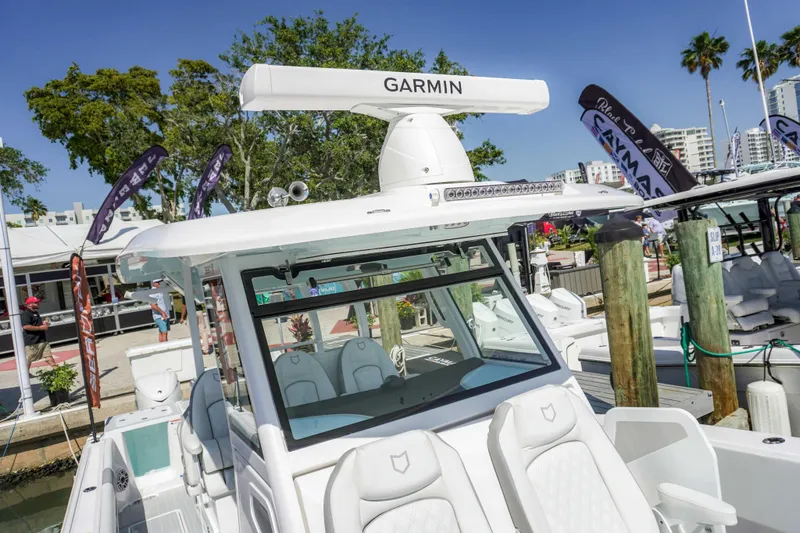 The Reel Commander Yacht Photos Pics 2026 Sea Fox 368 Commander boat docked, featuring Garmin equipment, in a sunny marina setting.