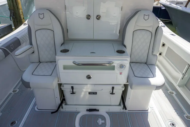 The Reel Commander Yacht Photos Pics 2026 Sea Fox 368 Commander boat interior with cushioned seating and storage.