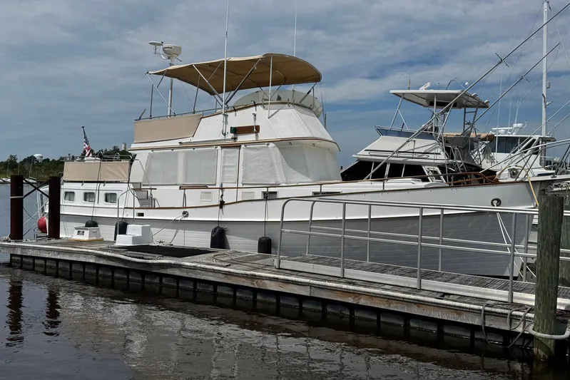 Carolina Breeze Yacht Photos Pics 1989 Grand Banks 42 Motor Yacht docked at marina under cloudy sky.