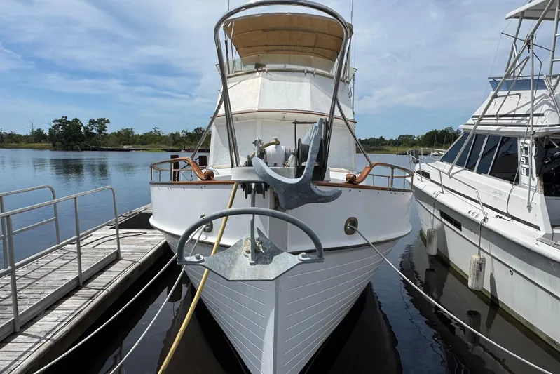Carolina Breeze Yacht Photos Pics 1989 Grand Banks 42 Motor Yacht docked at marina, front view with anchor.