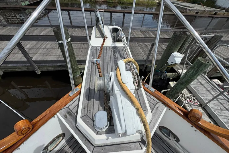 Carolina Breeze Yacht Photos Pics 1989 Grand Banks 42 Motor Yacht bow with anchor chain and wooden railings at dock.