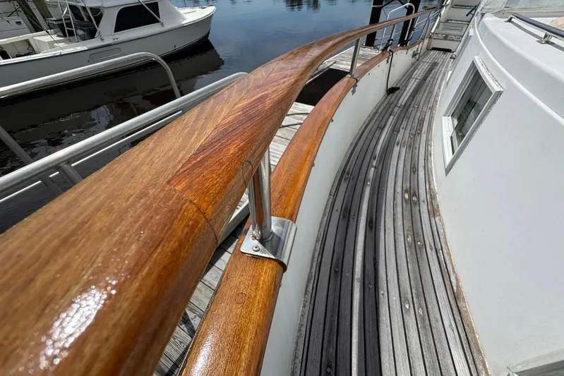 Carolina Breeze Yacht Photos Pics Polished wooden railing on 1989 Grand Banks 42 Motor Yacht deck, docked at marina.