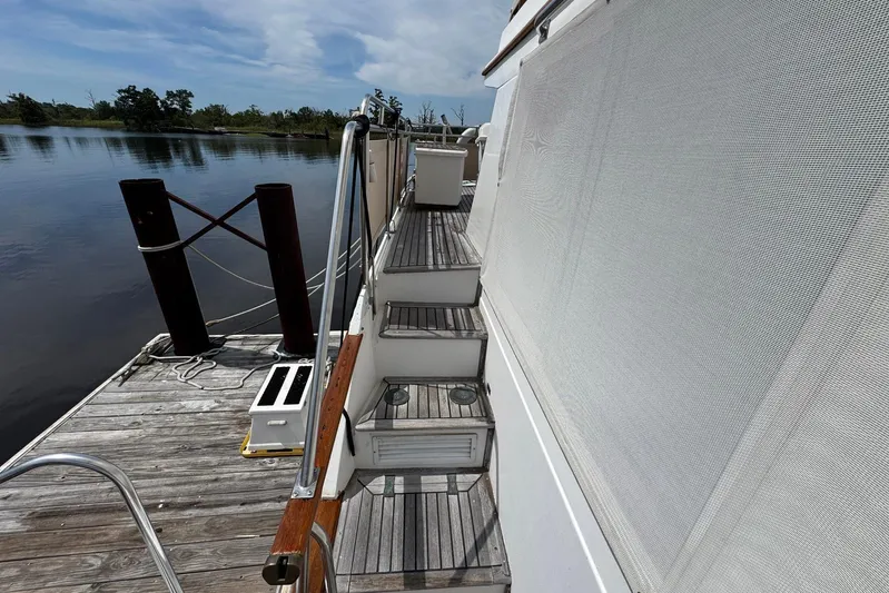 Carolina Breeze Yacht Photos Pics 1989 Grand Banks 42 Motor Yacht docked, showing side deck and steps with railing.