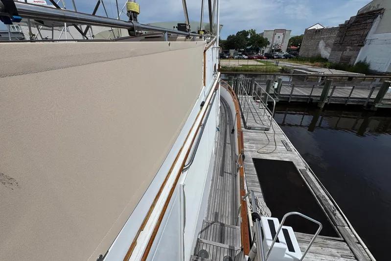 Carolina Breeze Yacht Photos Pics 1989 Grand Banks 42 Motor Yacht docked, showcasing deck and railing details.