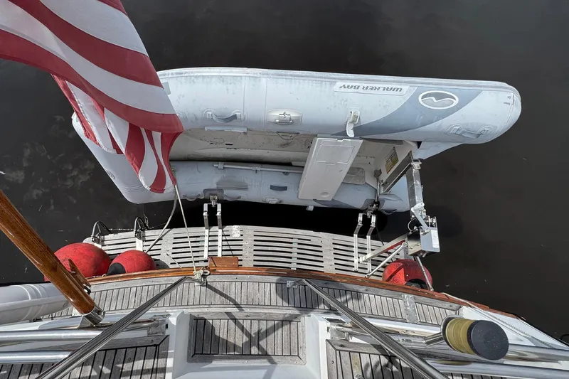Carolina Breeze Yacht Photos Pics Grand Banks 42 Motor Yacht 1989 with dinghy and American flag on deck.