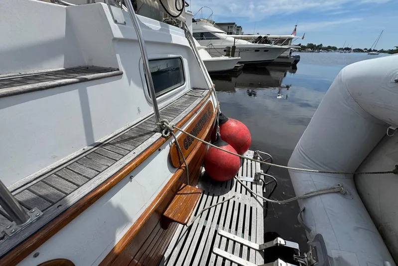 Carolina Breeze Yacht Photos Pics 1989 Grand Banks 42 Motor Yacht docked with inflatable boat and red buoys.