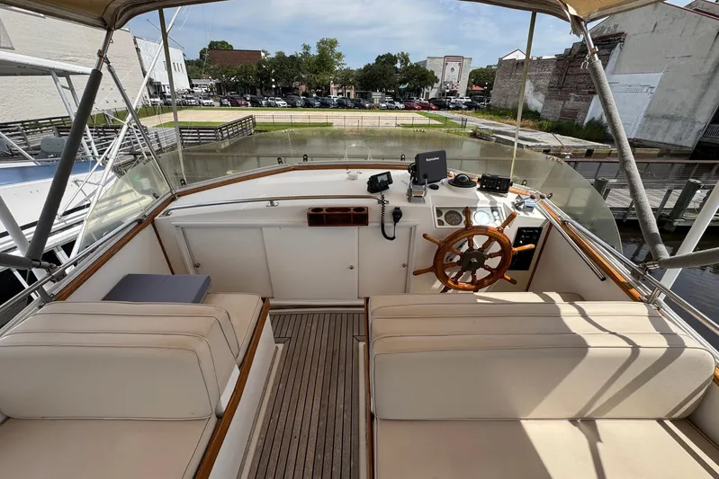 Carolina Breeze Yacht Photos Pics 1989 Grand Banks 42 Motor Yacht helm with wooden wheel and navigation equipment.
