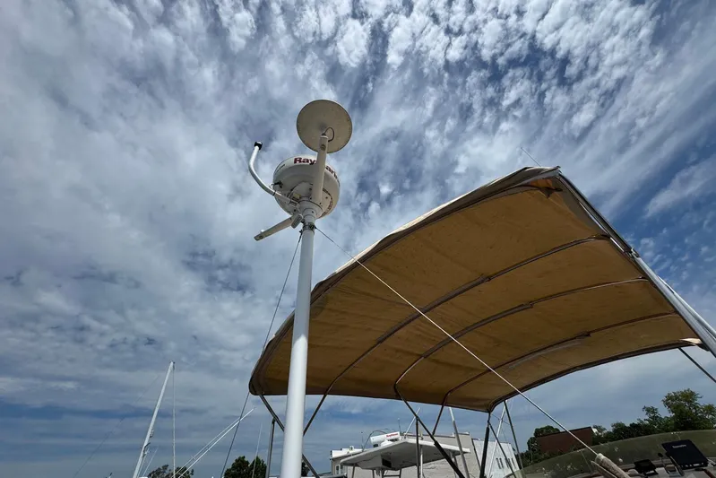 Carolina Breeze Yacht Photos Pics Radar equipment on 1989 Grand Banks 42 Motor Yacht under cloudy sky.