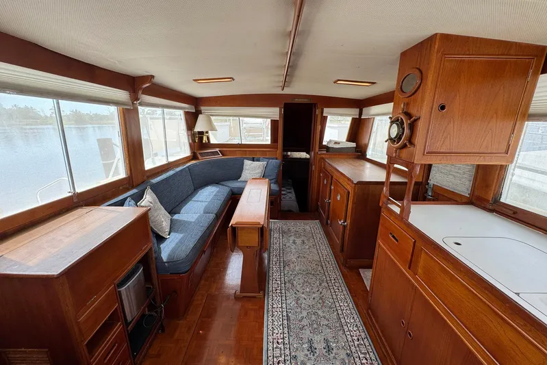 Carolina Breeze Yacht Photos Pics Interior of 1989 Grand Banks 42 Motor Yacht with wooden furnishings and blue seating.