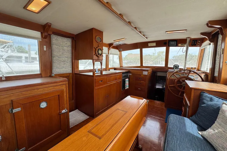 Carolina Breeze Yacht Photos Pics 1989 Grand Banks 42 Motor Yacht interior with wooden cabinetry and helm station.