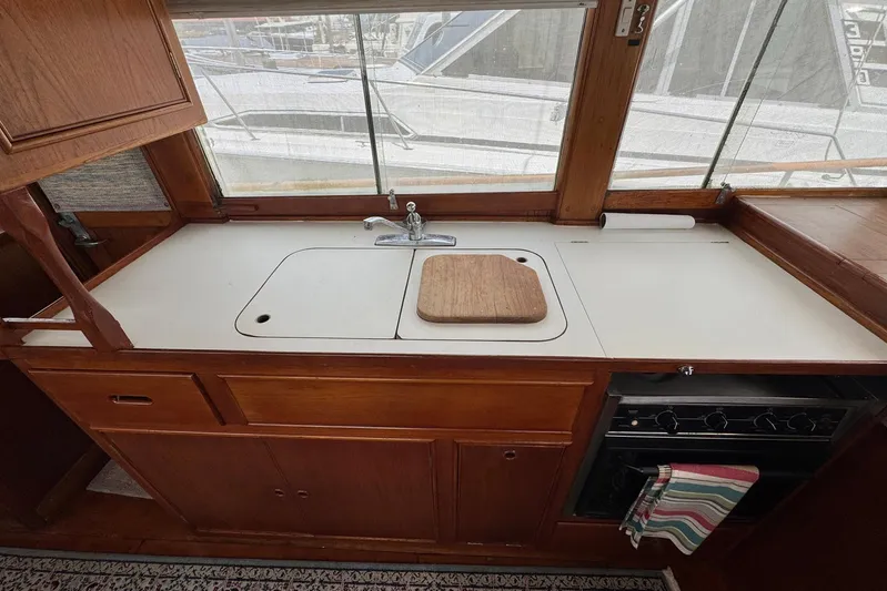 Carolina Breeze Yacht Photos Pics Galley kitchen in 1989 Grand Banks 42 Motor Yacht with sink and stove.