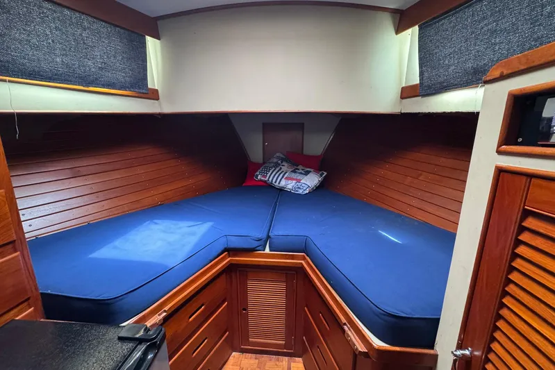Carolina Breeze Yacht Photos Pics Cozy cabin interior of 1989 Grand Banks 42 Motor Yacht with blue bedding.