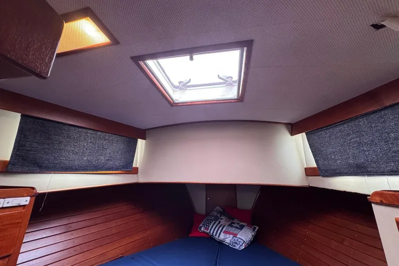 Carolina Breeze Yacht Photos Pics Cozy cabin interior of 1989 Grand Banks 42 Motor Yacht with skylight and cushions.