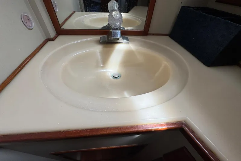 Carolina Breeze Yacht Photos Pics Bathroom sink in 1989 Grand Banks 42 Motor Yacht with wooden trim and mirror.