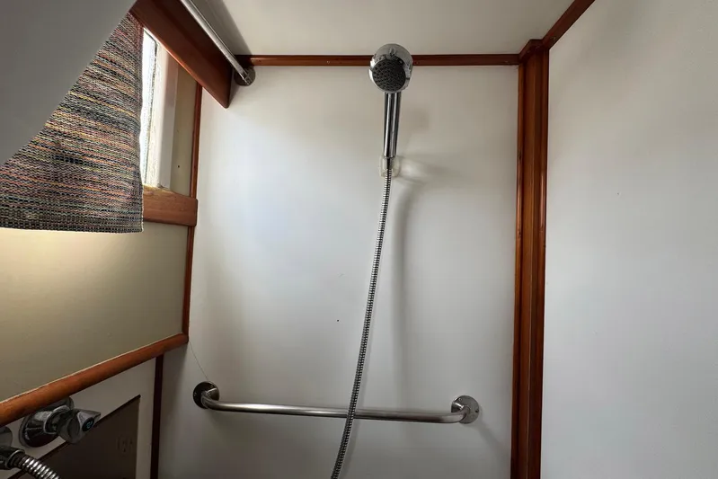 Carolina Breeze Yacht Photos Pics Shower area in 1989 Grand Banks 42 Motor Yacht with handheld showerhead and grab bar.
