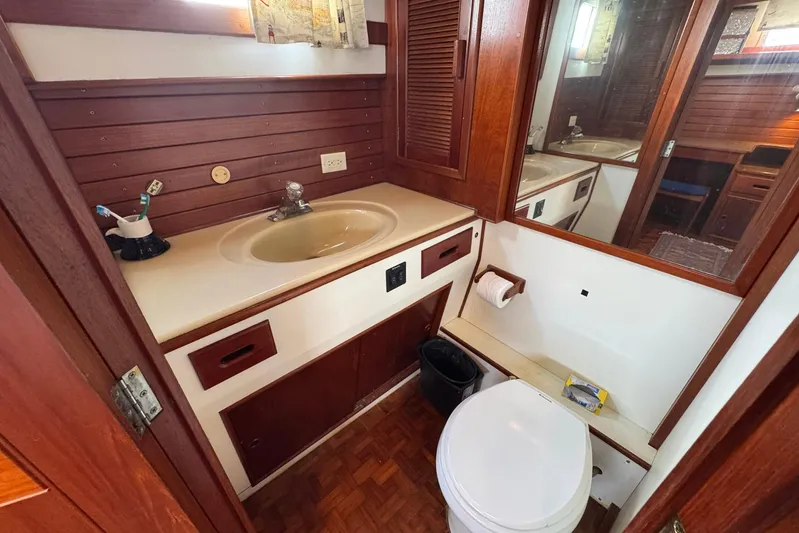 Carolina Breeze Yacht Photos Pics 1989 Grand Banks 42 Motor Yacht bathroom with wooden cabinetry and sink.