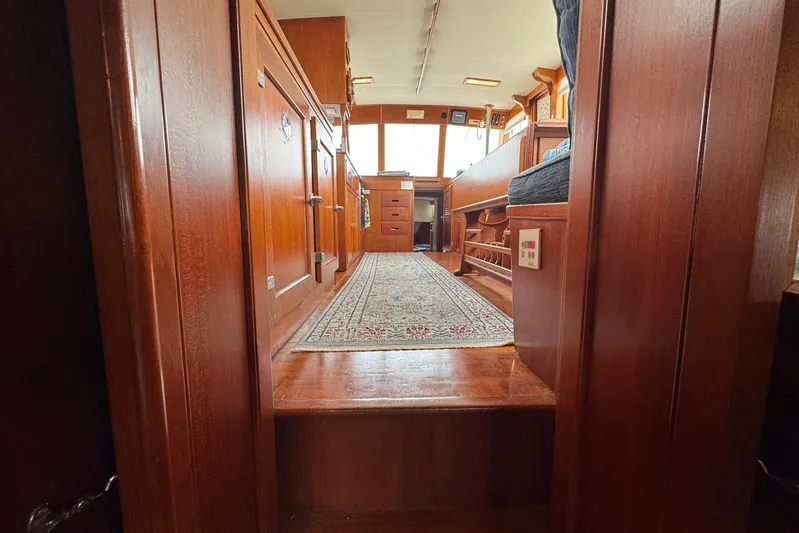 Carolina Breeze Yacht Photos Pics Interior of 1989 Grand Banks 42 Motor Yacht with wooden cabinetry and carpeted floor.
