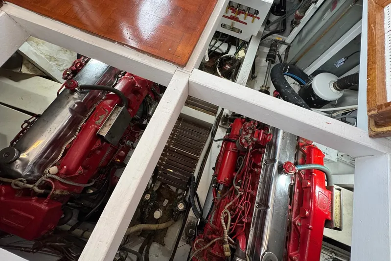 Carolina Breeze Yacht Photos Pics Engine room of 1989 Grand Banks 42 Motor Yacht with red engines and mechanical components.