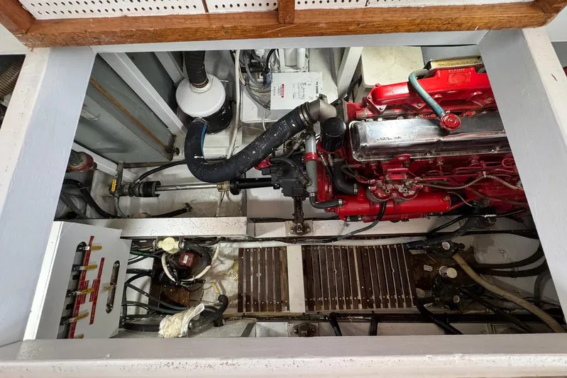 Carolina Breeze Yacht Photos Pics Engine room of 1989 Grand Banks 42 Motor Yacht with visible red engine components.