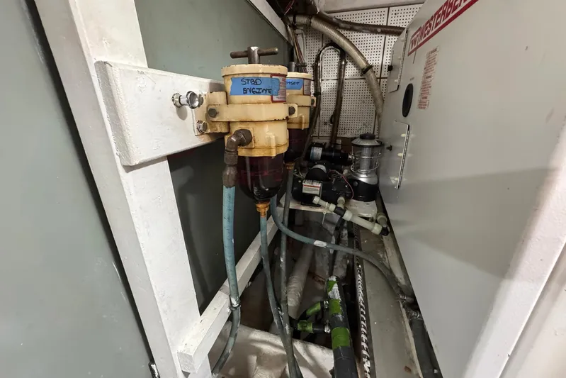 Carolina Breeze Yacht Photos Pics Engine room of 1989 Grand Banks 42 Motor Yacht with fuel filters and hoses.