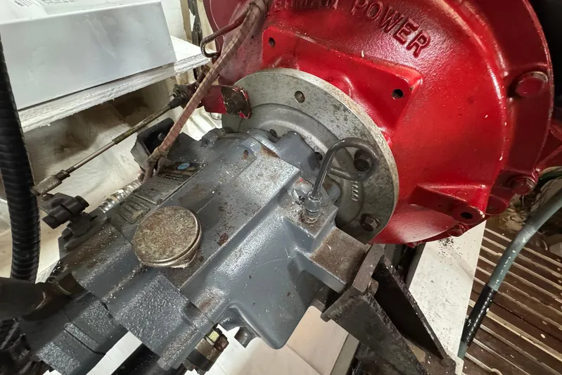 Carolina Breeze Yacht Photos Pics Engine component of 1989 Grand Banks 42 Motor Yacht, featuring red and gray machinery.