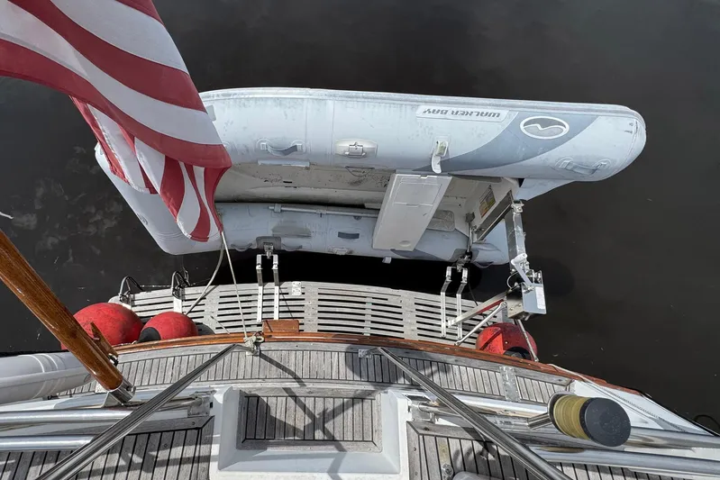 Carolina Breeze Yacht Photos Pics 1989 Grand Banks 42 Motor Yacht with dinghy and American flag on deck.