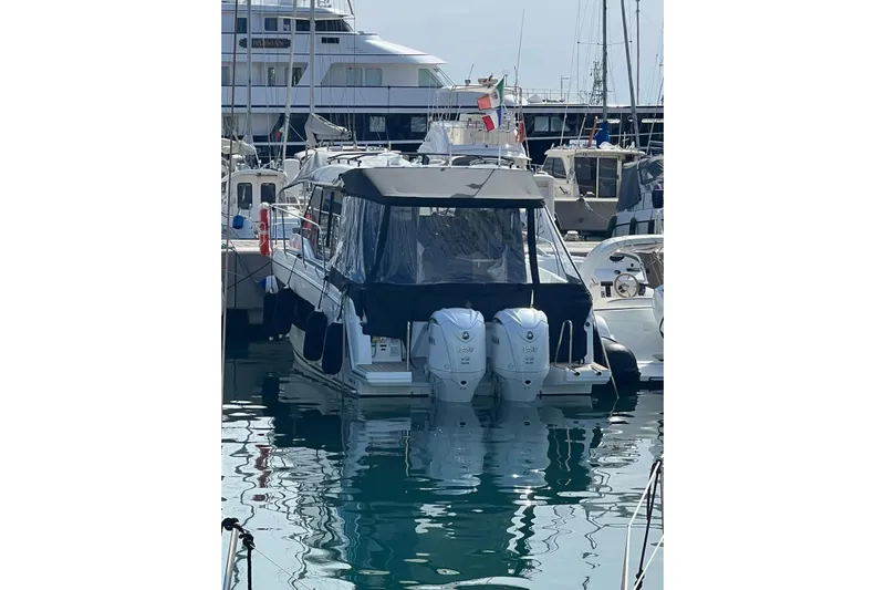  Yacht Photos Pics 2024 Jeanneau Merry Fisher 895 docked with twin outboard engines.