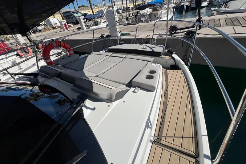  Yacht Photos Pics 2024 Jeanneau Merry Fisher 895 boat deck with sunbathing area and cup holders.