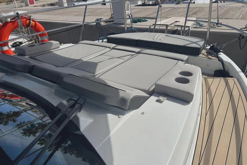  Yacht Photos Pics 2024 Jeanneau Merry Fisher 895 boat with sunbathing deck and cup holders.