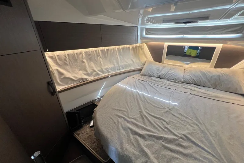  Yacht Photos Pics 2024 Jeanneau Merry Fisher 895 cabin interior with bed and modern lighting.