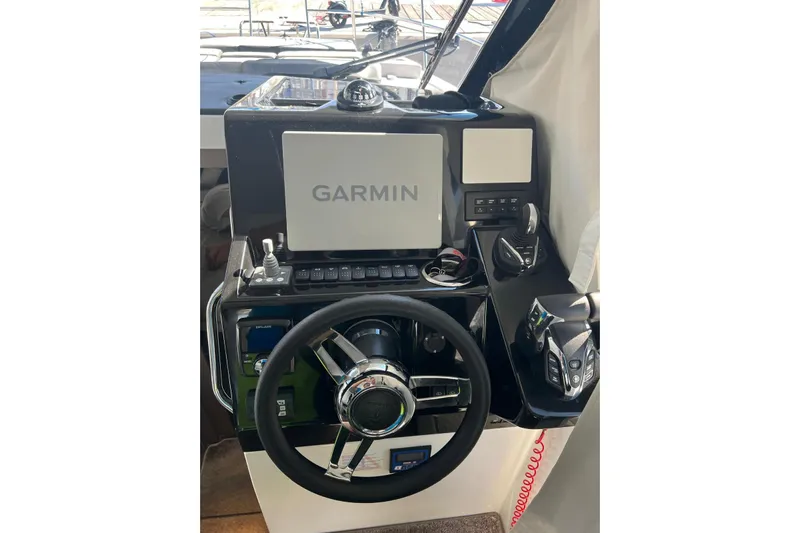  Yacht Photos Pics 2024 Jeanneau Merry Fisher 895 helm with Garmin navigation system and modern controls.