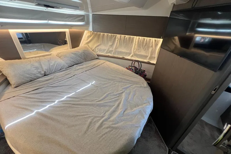  Yacht Photos Pics 2024 Jeanneau Merry Fisher 895 cabin interior with cozy bed and modern decor.