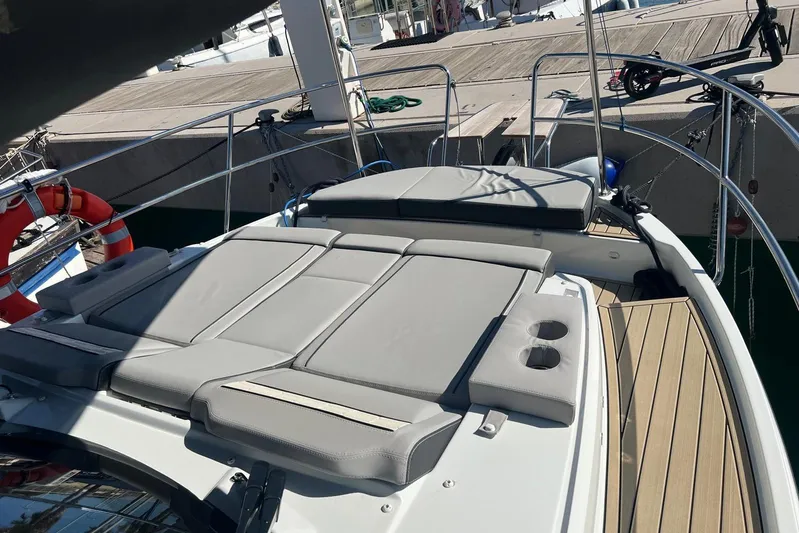  Yacht Photos Pics 2024 Jeanneau Merry Fisher 895 boat with sunbathing deck and cup holders.