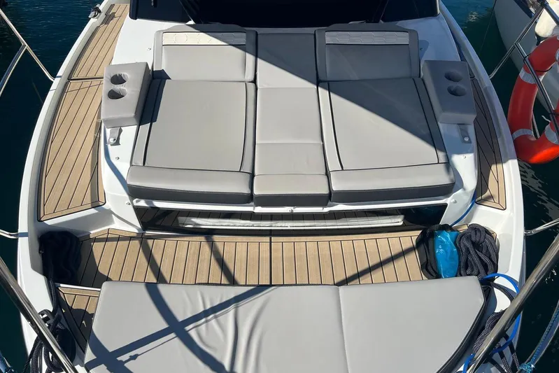  Yacht Photos Pics 2024 Jeanneau Merry Fisher 895 boat with spacious sun deck and cushioned seating.