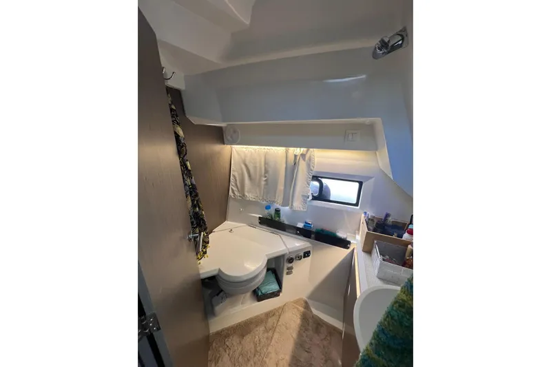  Yacht Photos Pics 2024 Jeanneau Merry Fisher 895 bathroom interior with modern fixtures and window.