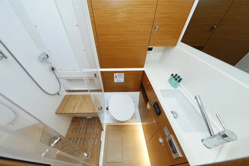 Volare Yacht Photos Pics Modern bathroom interior of 2025 Hanse 590 yacht with wooden accents and sleek fixtures.